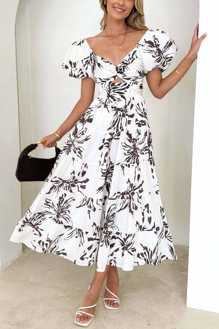 Renske – Gebloemde Midi Jurk met Pofmouwen en Cut-out Detail