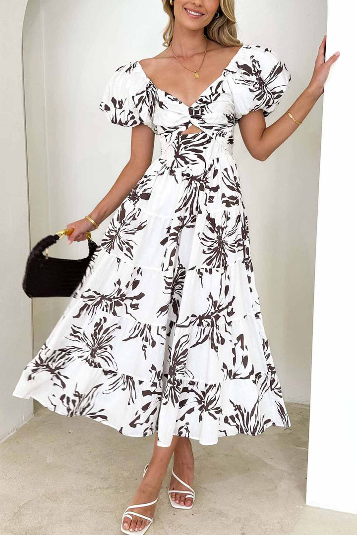 Renske – Gebloemde Midi Jurk met Pofmouwen en Cut-out Detail
