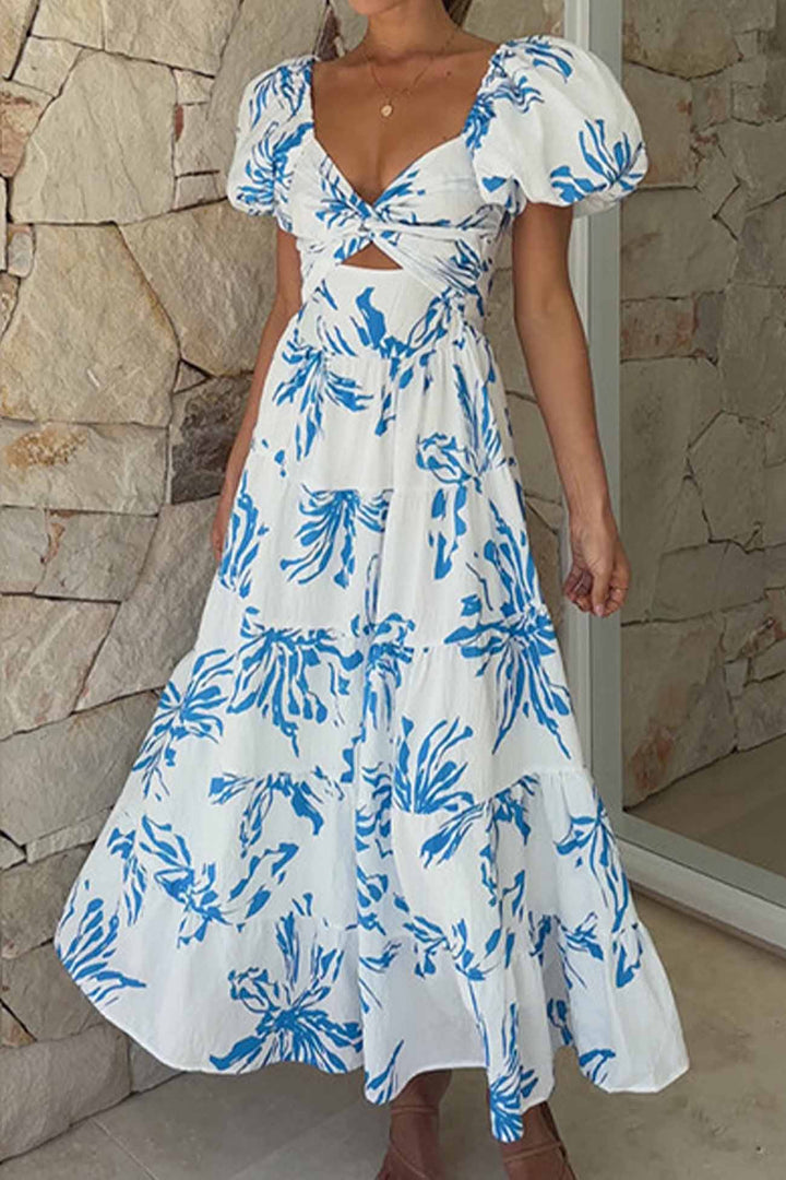 Renske – Gebloemde Midi Jurk met Pofmouwen en Cut-out Detail