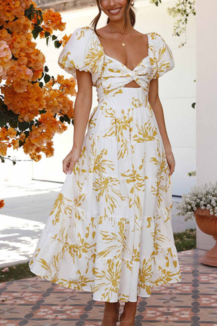 Renske – Gebloemde Midi Jurk met Pofmouwen en Cut-out Detail