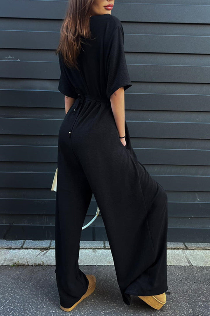 Isa – Jumpsuit met V-Hals, Strikceintuur en Wijde Pijpen
