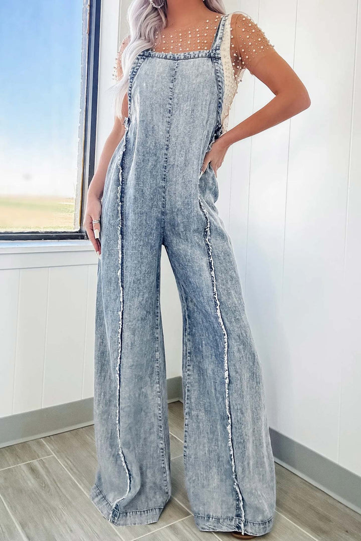 Nora – Washed Denim Jumpsuit met Ruwe Zoom en Wijde Pijpen