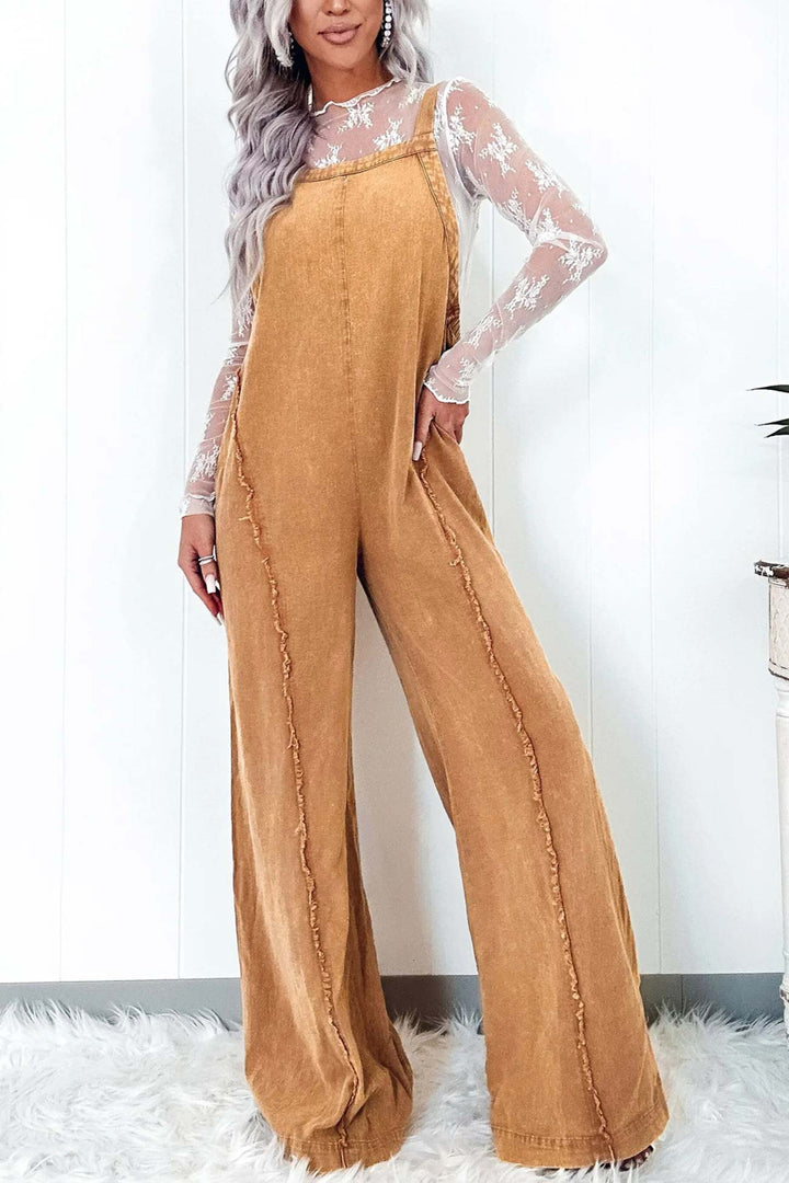 Nora – Washed Denim Jumpsuit met Ruwe Zoom en Wijde Pijpen