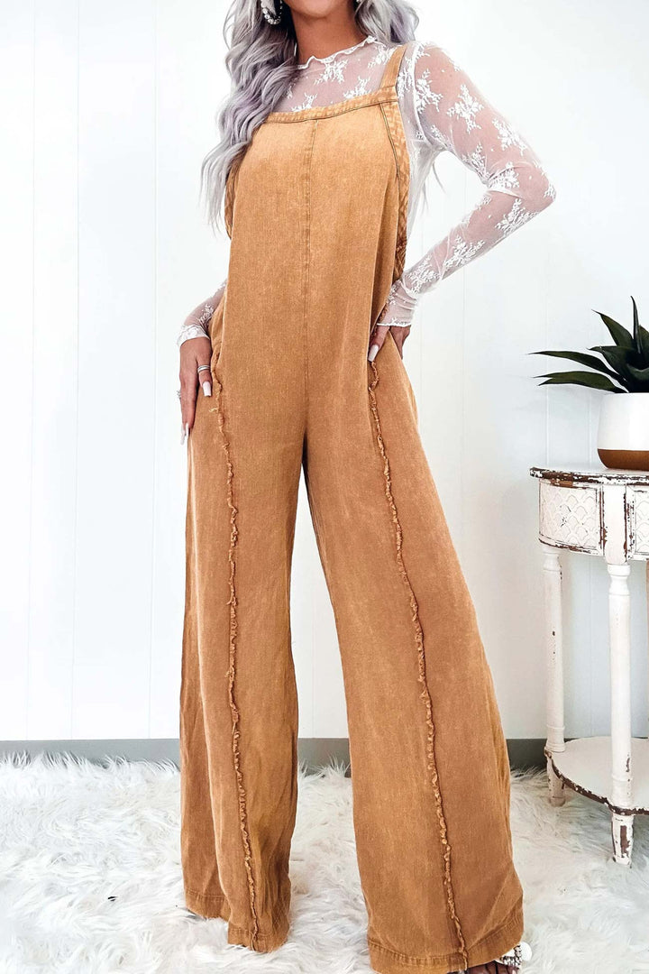 Nora – Washed Denim Jumpsuit met Ruwe Zoom en Wijde Pijpen